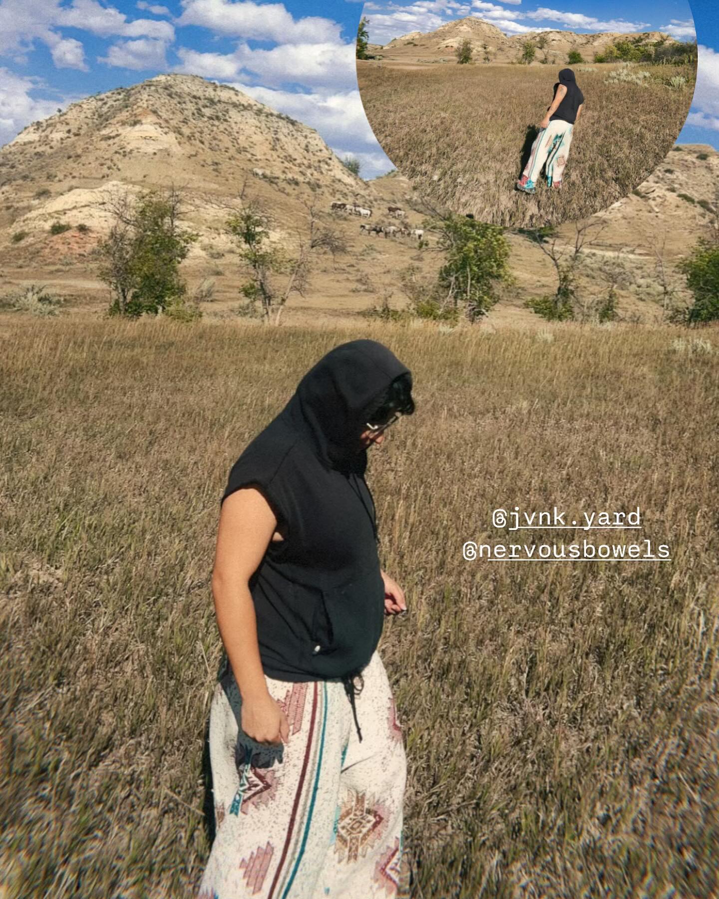 Tapestry pants worn through dry grass